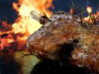 leg of lamb with flames in the background